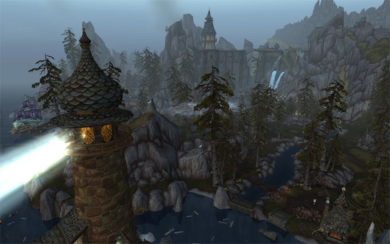 Aerieal screenshot of the Battle for Gilneas Battleground. Light beams from a lighthouse left towards the sea.