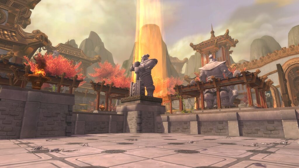 The inside of the Temple of Kotmogu Battleground. A column of sunlight beams directly down on a pandaren statue.